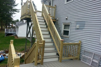 Example of a mid-sized classic backyard second story wood railing deck design in Boston with no cover