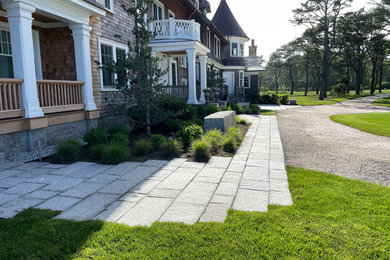 Photo of a large coastal full sun front yard stone landscaping in Portland Maine.