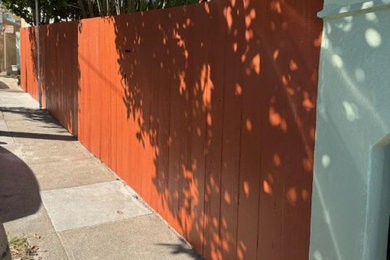 Inspiration for a mid-sized modern partial sun hillside wood fence formal garden in San Francisco.