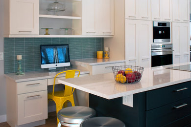 Trendy u-shaped light wood floor eat-in kitchen photo in Milwaukee with recessed-panel cabinets, white cabinets, quartzite countertops, glass tile backsplash, stainless steel appliances, an undermount sink, green backsplash and an island