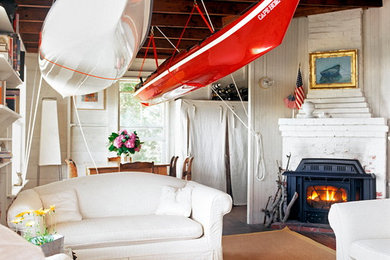 Inspiration for a small coastal formal and open concept dark wood floor living room remodel in New York with white walls, a corner fireplace, a brick fireplace and no tv