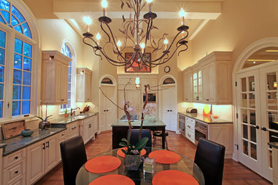 Large trendy galley medium tone wood floor eat-in kitchen photo in Atlanta with an undermount sink, raised-panel cabinets, white cabinets, stainless steel appliances and an island