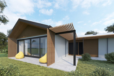 Diseño de fachada de casa actual de tamaño medio de una planta con todos los materiales de revestimiento, tejado a dos aguas y tejado de metal