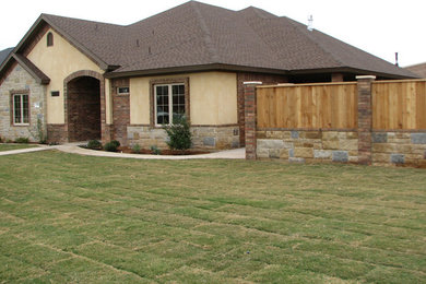 Mid-sized traditional beige one-story mixed siding exterior home idea in Austin with a hip roof