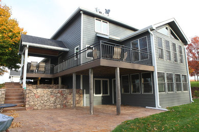 Inspiration for a mid-sized contemporary two-story concrete gable roof remodel in Other