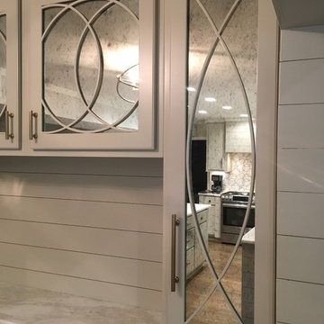 Custom cabinets with circular grilles and antique mirror glass