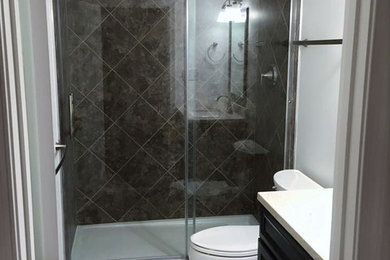 Small transitional gray tile ceramic tile alcove shower photo in DC Metro with recessed-panel cabinets, black cabinets, a two-piece toilet and white walls
