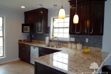 Photo of a transitional kitchen in Other with raised-panel cabinets and dark wood cabinets.