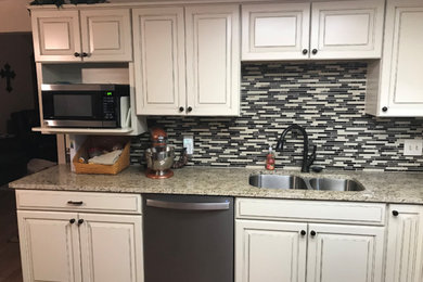 Mid-sized traditional l-shaped separate kitchen in Oklahoma City with an undermount sink, raised-panel cabinets, granite benchtops, beige splashback, mosaic tile splashback and no island.