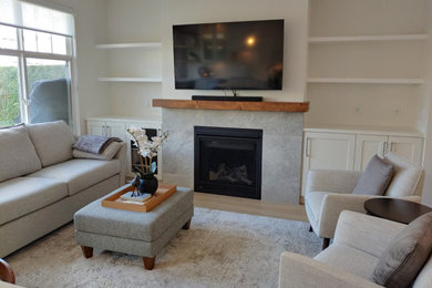 Family room - small transitional open concept light wood floor and brown floor family room idea in Vancouver with white walls, a standard fireplace and a wall-mounted tv