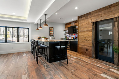 Minimalist galley seated home bar photo with shaker cabinets and black cabinets