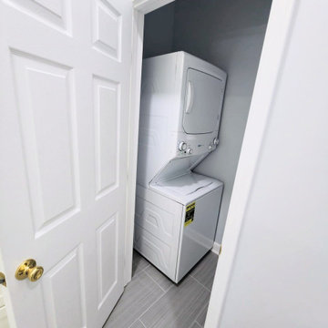 Compact Laundry Room with Stackable Washer & Dryer