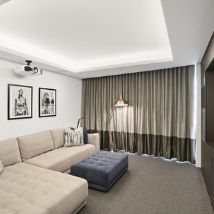 Inspiration for a mid-sized contemporary enclosed carpeted home theater remodel in Sydney with white walls and a projector screen