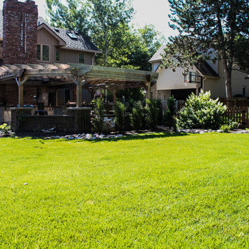 Luxury Lawn with Mulch, Bushes, Small Trees, and Custom Rock Formation