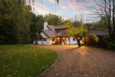Design ideas for a white classic front detached house in Hampshire with wood cladding.