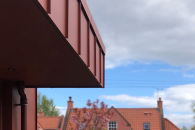 Design ideas for a contemporary bungalow house exterior in Edinburgh with metal cladding.