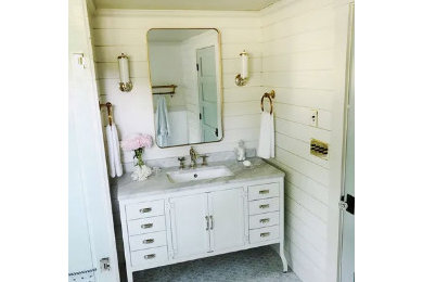 Example of a mid-sized beach style master multicolored floor and single-sink freestanding bathtub design in Boston with gray walls, an undermount sink, marble countertops, white countertops and a freestanding vanity