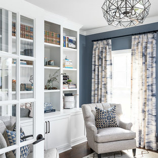 Rural study in Chicago with blue walls, dark hardwood flooring and brown floors.