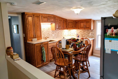 Elegant l-shaped vinyl floor and multicolored floor kitchen photo in Other with an undermount sink, raised-panel cabinets, medium tone wood cabinets, quartzite countertops, multicolored backsplash, stone tile backsplash, stainless steel appliances, no island and multicolored countertops