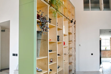 Photo of a large contemporary straight wood railing staircase in London.