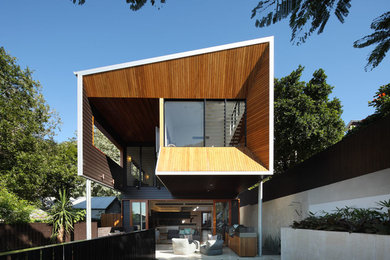 This is an example of a contemporary two-storey exterior in Brisbane with wood siding.