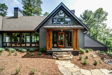 Example of a large mountain style gray three-story vinyl gable roof design in Other