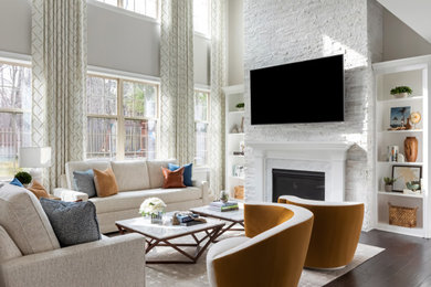 Mid-sized minimalist open concept medium tone wood floor and brown floor living room photo in Raleigh with gray walls, a standard fireplace, a stone fireplace and a wall-mounted tv