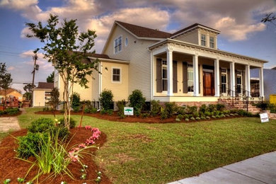 Example of a beige two-story mixed siding exterior home design in New Orleans