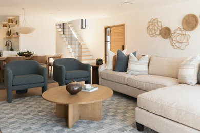Mid-sized beach style open concept light wood floor living room photo in Orange County with white walls, a standard fireplace and a stone fireplace