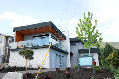 Inspiration for a mid-sized modern gray two-story stucco exterior home remodel in Vancouver