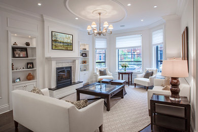 Inspiration for a large timeless formal and enclosed dark wood floor living room remodel in Chicago with white walls, a standard fireplace, a wood fireplace surround and no tv