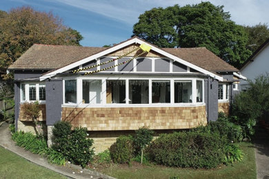 This is an example of an exterior in Sydney with wood siding and a shingle roof.