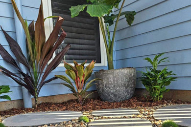 This is an example of a small contemporary front yard stone walkway in Sunshine Coast.