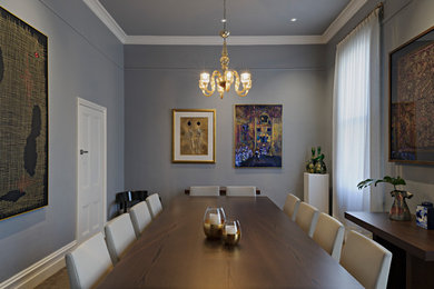 Photo of a mid-sized contemporary dining room in Melbourne with grey walls, carpet and no fireplace.