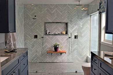 Walk-in shower - mid-sized contemporary master gray tile and marble tile pebble tile floor and brown floor walk-in shower idea in Los Angeles with recessed-panel cabinets, gray walls, an undermount sink, quartzite countertops, gray countertops, a niche and a built-in vanity