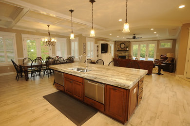 Arts and crafts ceramic tile eat-in kitchen photo in Portland Maine with an undermount sink, raised-panel cabinets, dark wood cabinets, granite countertops, beige backsplash, ceramic backsplash, stainless steel appliances and an island