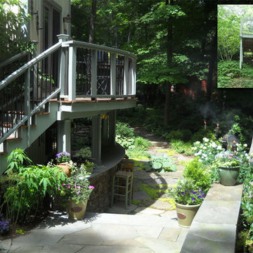 Curved deck steps lead to a bluestone terrace. A curved stone bar is located be