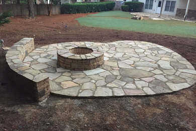 Inspiration for a mid-sized timeless backyard stone patio remodel in Atlanta with a fire pit and no cover