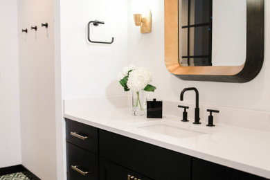 Inspiration for a mid-sized transitional 3/4 black tile and porcelain tile cement tile floor and multicolored floor bathroom remodel in Austin with flat-panel cabinets, black cabinets, quartz countertops, white countertops, a one-piece toilet, white walls, a drop-in sink and a hinged shower door