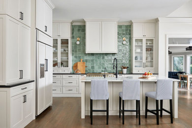 Transitional kitchen photo in Atlanta with shaker cabinets, marble countertops, green backsplash, ceramic backsplash and an island