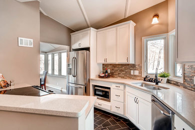 Inspiration for a mid-sized transitional u-shaped slate floor and gray floor enclosed kitchen remodel in Minneapolis with an undermount sink, shaker cabinets, white cabinets, granite countertops, multicolored backsplash, matchstick tile backsplash, stainless steel appliances, a peninsula and beige countertops