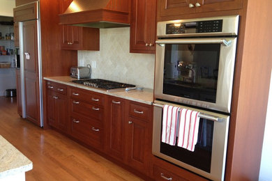 Inspiration for a mid-sized timeless galley open concept kitchen remodel in Other with medium tone wood cabinets and an island