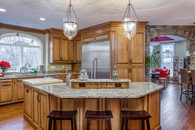Eat-in kitchen - rustic u-shaped brown floor eat-in kitchen idea in Other with an undermount sink, stainless steel appliances and an island