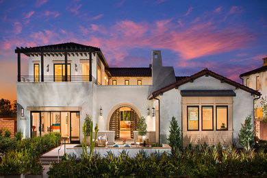 Large two-storey white house exterior in San Diego with a gable roof and a metal roof.