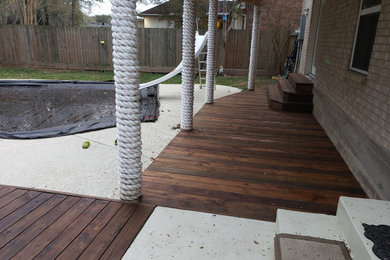 Deck - mid-sized backyard ground level deck idea in Houston with a roof extension
