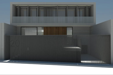 Foto de fachada de casa gris grande de dos plantas con revestimiento de hormigón y escaleras