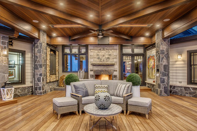 Example of a large minimalist courtyard patio kitchen design in Calgary with decking and a roof extension
