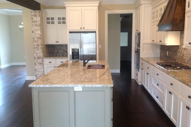Open concept kitchen - mid-sized transitional l-shaped dark wood floor open concept kitchen idea in Other with an island, a double-bowl sink, recessed-panel cabinets, white cabinets, granite countertops, multicolored backsplash, stone tile backsplash and stainless steel appliances