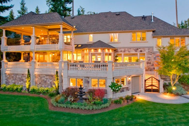 Example of a large tuscan three-story mixed siding house exterior design in Seattle with a hip roof and a shingle roof