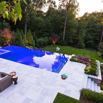Luxury vanishing edge swimming pool and outdoor living area Ridgewood NJ